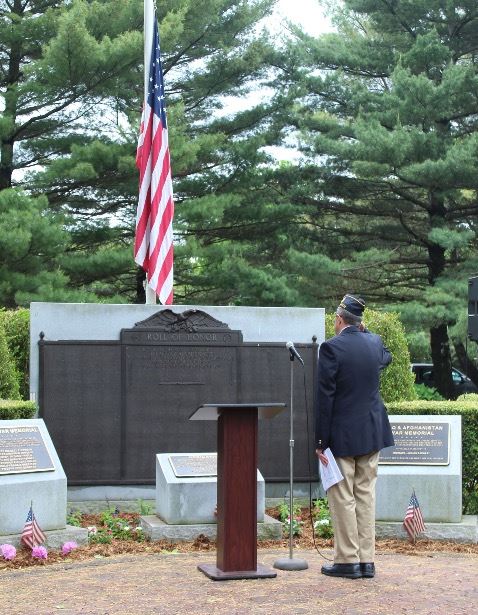 American Legion Commander salutes flag at Memorial Day ceremony