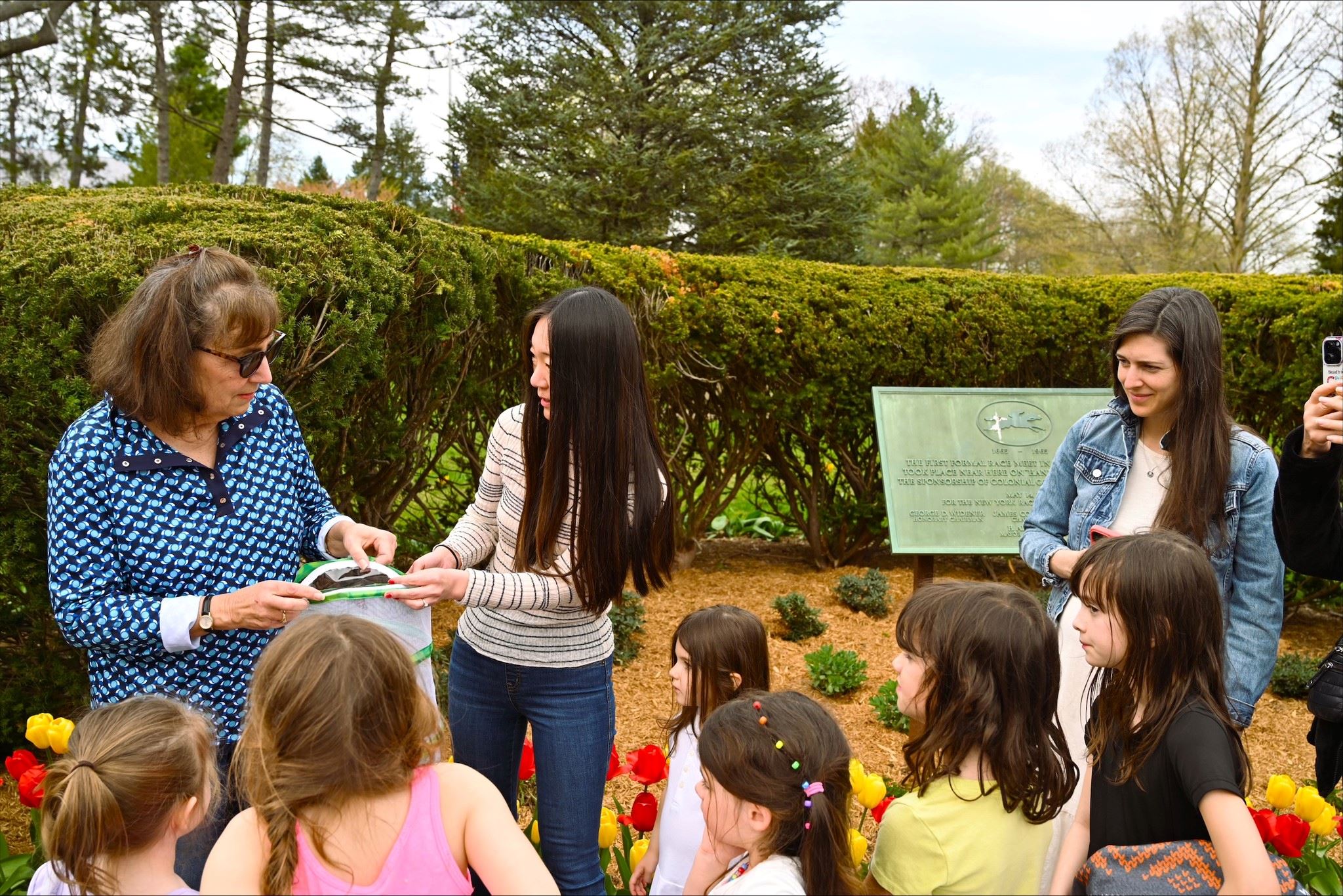 Releasing butterflies in the new pollinator garden on the Village Green.